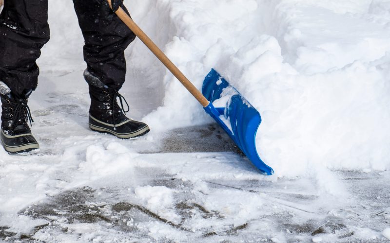 Man Removing Snow from His Driveway